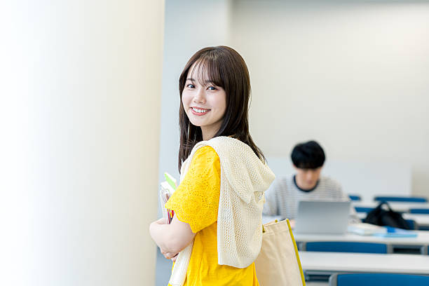 istock college student walking through the classroom 2243875957