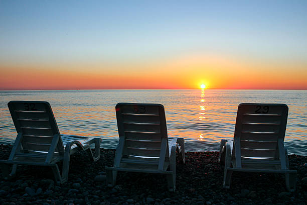 istock Beach loungers on the seashore during sunset 2243877492