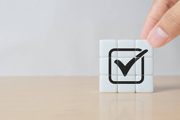 istock Hand assemble correct tick sign mark on dice for document approve business project and quality assurance concept. 2243878178