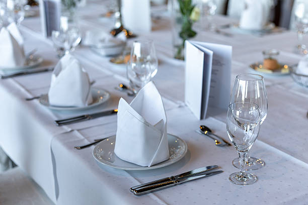 istock Elegant dining setup with folded napkins, glassware, and menus in a bright restaurant 2243882106