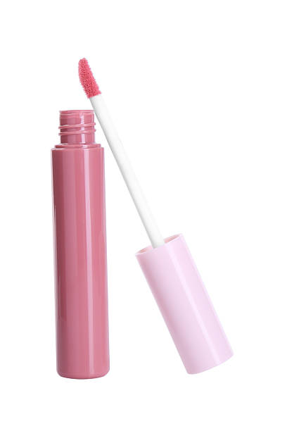 istock Pink lip gloss and applicator isolated on white. Cosmetic product 2243882947