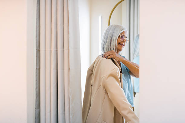 Senior woman browsing luxury shop interior