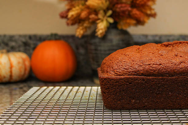 Fresh Homemade Pumpkin Bread Cooling on Wire Rack with Warm Fall Colors
