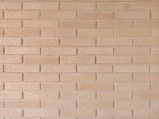 istock warmtoned clay brick backdrop, horizontal textured clay brick surface with shadows and uniform 2243888794