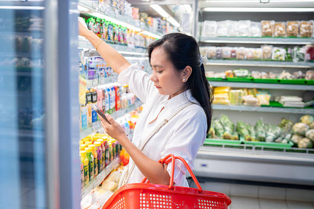istock Woman comparing bottled drinks in supermarket 2243891948