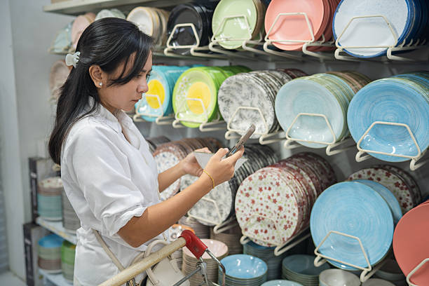 istock Woman checking ceramic plates at supermarket 2243892039