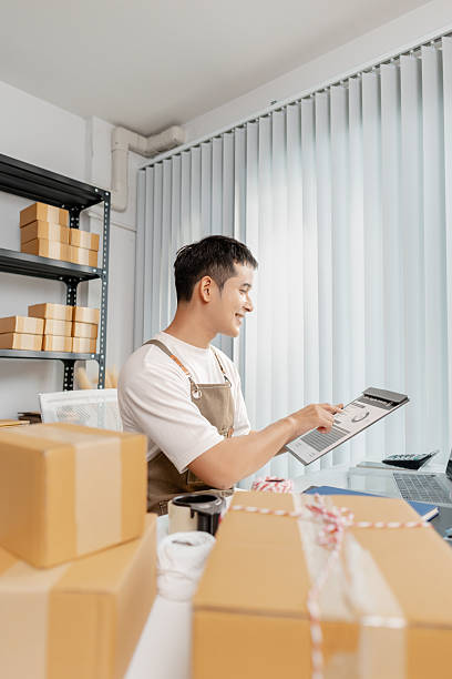 istock Young entrepreneur managing online business, preparing packages and working with e commerce operations, representing digital marketplace, startup growth and modern retail strategy. 2243892629
