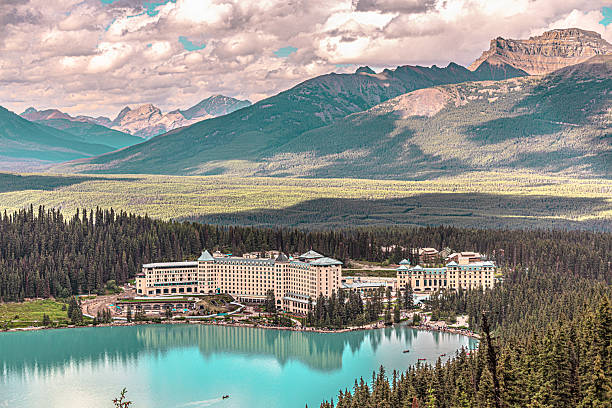 Banff National Park, Canada - July 24, 2025: Lake Louise is a glacial lake known by its vibrant turquoise color inside Banff National Park. Fairmount Chateau Lake Louise, a luxury resort hotel is located on eastern shore.