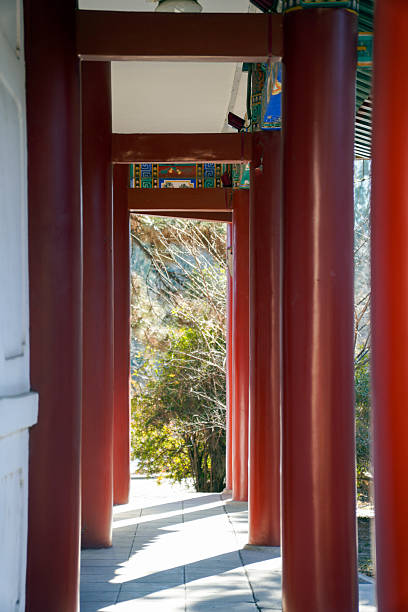 istock Traditional Chinese corridor with red pillars and natural scenery outside 2243895497