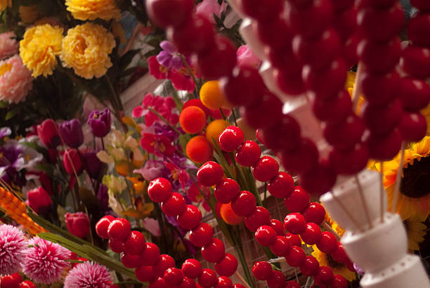 A display of colorful artificial flowers with diverse shapes and vivid colors, showcasing a beautiful floral arrangement.
