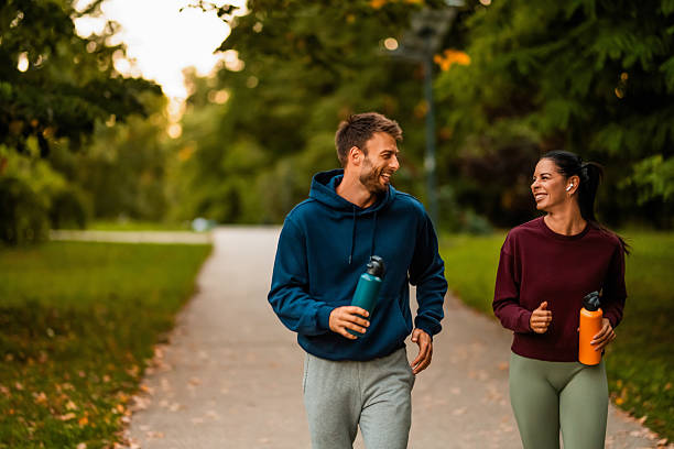 istock Cheerful athletic couple jogging through the park. 2243896316