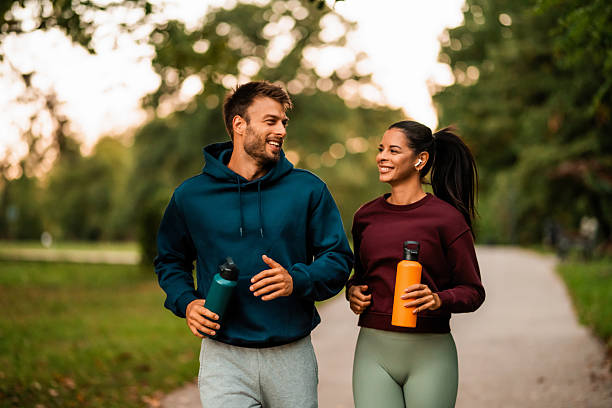 istock Cheerful athletic couple jogging through the park. 2243896914