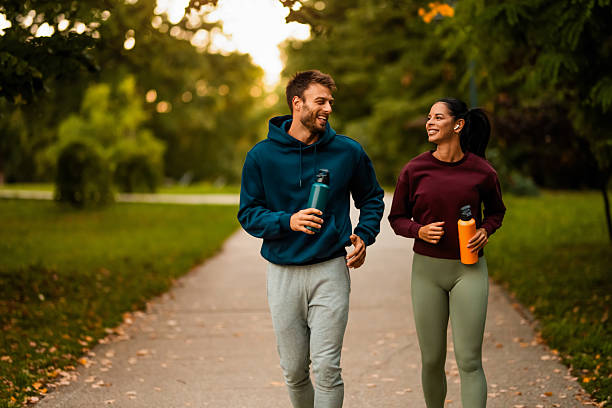 istock Cheerful athletic couple jogging through the park. 2243896989
