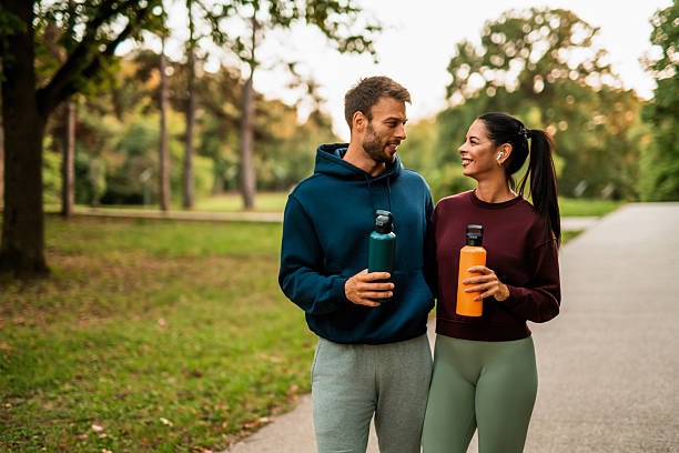 istock Happy athletic couple walking through the park. 2243897139