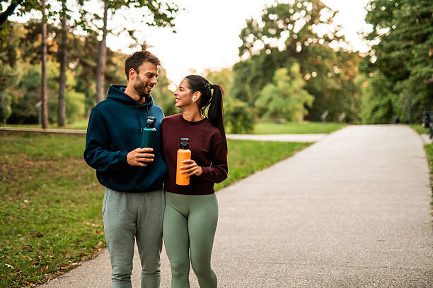 istock Happy athletic couple walking through the park. 2243897141