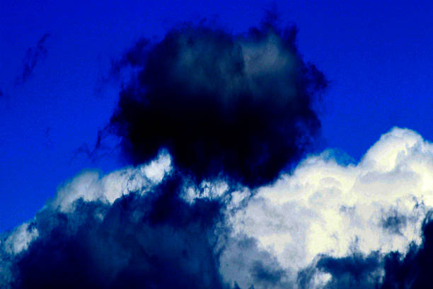 istock Dramatic blue sky with contrasting white cumulus and dark storm clouds 2243898392