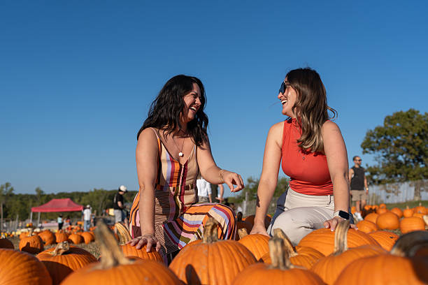 istock Friends picking pumpkins for Halloween 2243898406