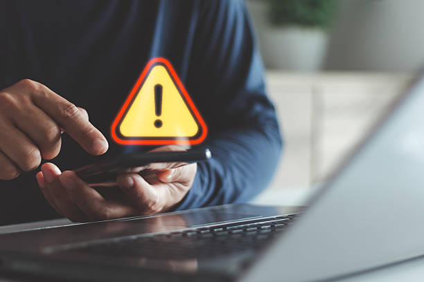 istock Cybersecurity alert concept showing a warning sign on a smartphone screen, symbolizing data breach, online scam or malware threat detection in digital communication and internet security systems. 2243903853