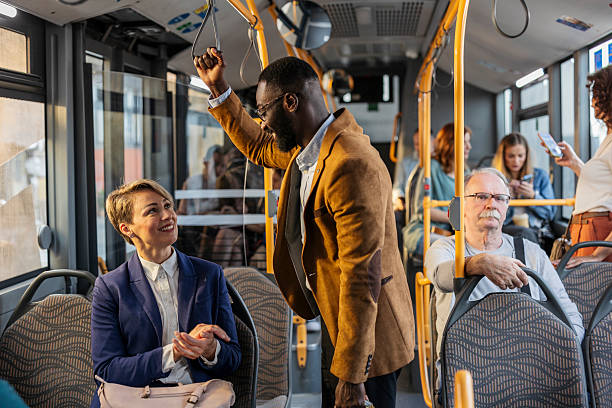 istock Diverse passengers commuting by public transport talking in a bus 2243904386