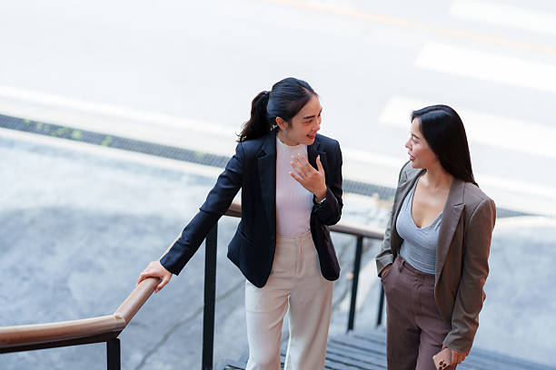 istock Businesswomen talking on urban stairs discussing work 2243907209