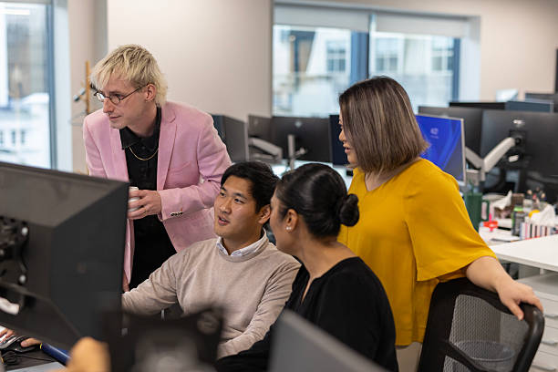istock Corporate colleague discussion at a desk with a computer 2243908045