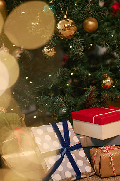 istock Christmas Gifts Arranged under Decorated Tree 2243909208