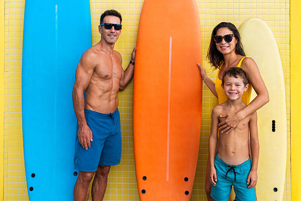 istock Happy family posing with surfboards ready for beach day 2243909363