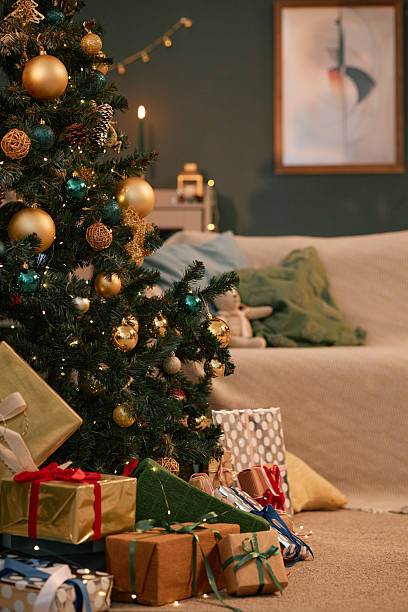 istock Christmas Tree with Presents Arranged Underneath in Cozy Living Room Setting 2243909498