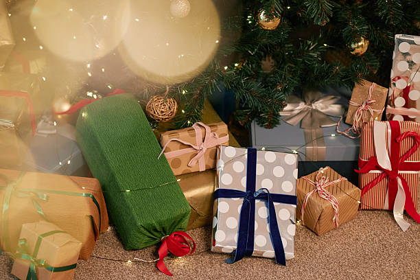 istock Assorted Wrapped Gifts Arranged under Christmas Tree Awaiting Celebration 2243909760