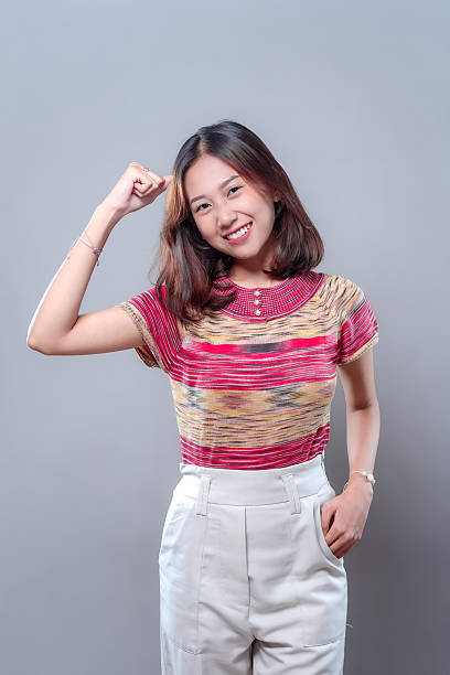 istock Cheerful Young Asian Woman Smiling with Confident Pose 2243912708