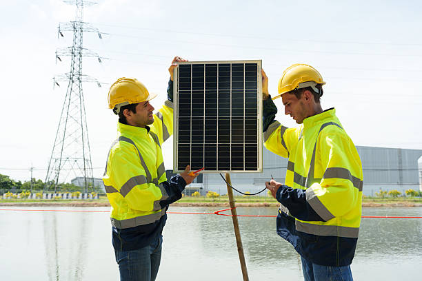 Electrical technicians are discussing the installation of solar panels.