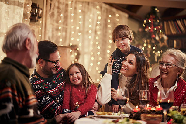 istock Cheerful extended family talking during Christmas dinner at home. 2243913875