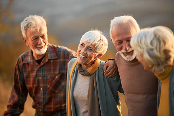 istock Happy mature couples talking while walking in autumn day. 2243914094