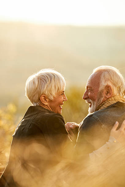 istock Happy senior couple talking during autumn day on a hill. 2243914239