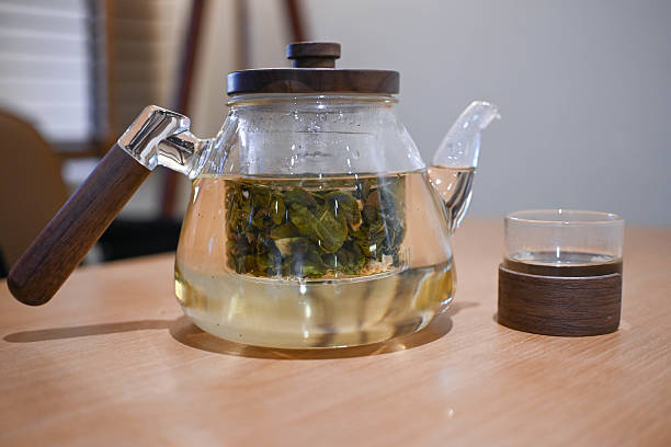 Glass of green tea and teapot