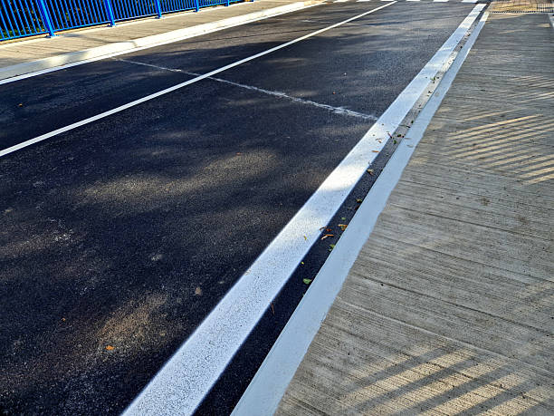 istock bridge railing with vertical fence post anchored into the ground with four concrete screws. the railing is fixed from  side of the bridge into the concrete. 2243915456