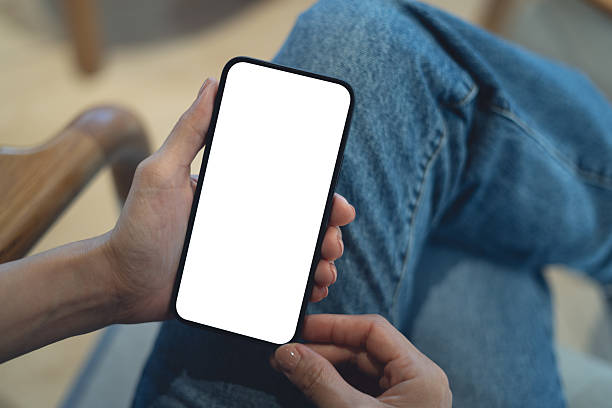 istock Mockup blank white screen mobile phone. Woman hand holding, using smartphone at coffee shop, template for mobile app design, social media marketing, close up 2243916889
