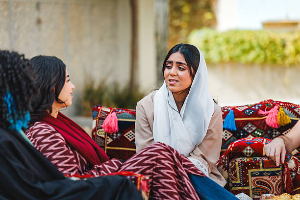 istock Middle Eastern Women Engaging in Friendly Conversation in Outdoor Majlis Setting 2243916965