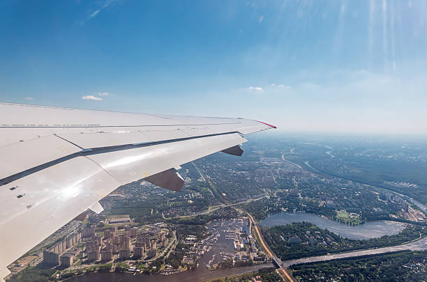 View from the airplane window during takeoff at Koltsovo airport on a clear summer morning