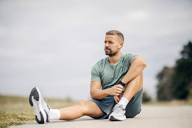 istock Male runner resting outdoors after workout, contemplating goals 2243919793