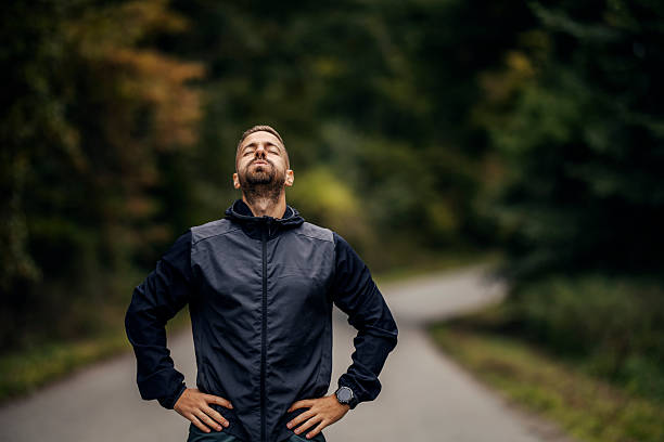 istock Man runner resting breathing deeply on outdoor road 2243920057