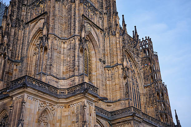 View of Gothic tower of St Vitus Cathedral with clock and tall spires at Prague Castle, Czech Republic. Concept of European architecture, history and religion