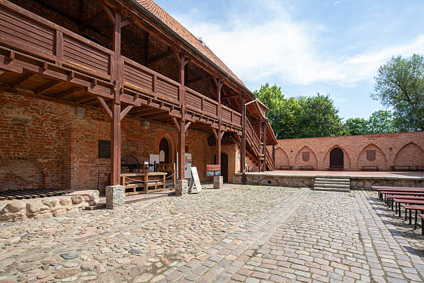 Ostroda, Poland - July 26, 2020: 14th century Teutonic order Ostroda Castle, red brick fortress built by Crusaders. In 1807, Napoleon Bonaparte lived in the castle. Castle was rebuilt in 20th century