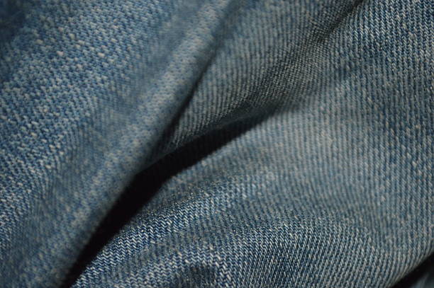A old blue jean fabric folded close photo