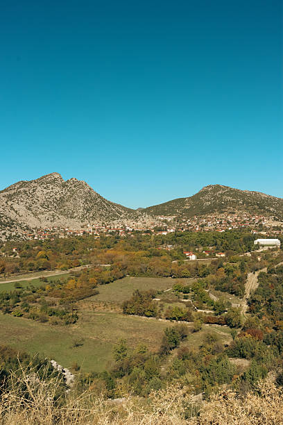 A breathtaking view of green mountains surrounded by lush vegetation, creating a peaceful and natural landscape.