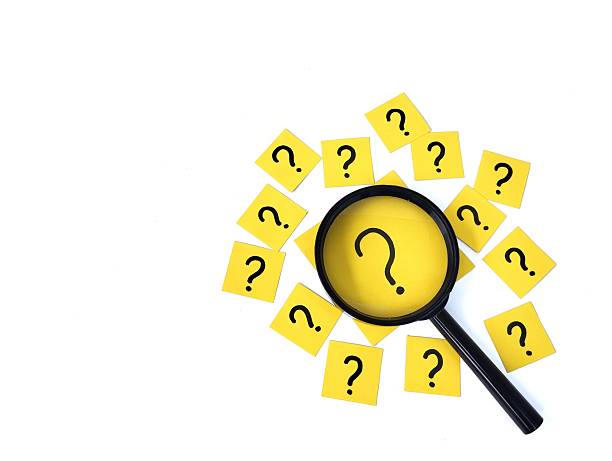 istock Question sign on note paper with magnifying glass on white background 2243923212