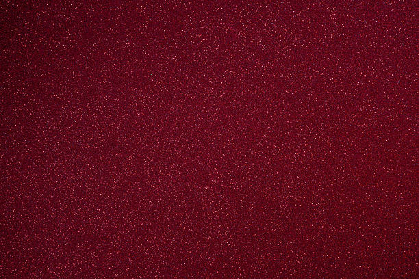 istock Bright burgundy glitter texture in macro with vivid sparkles and fine surface relief throughout 2243923429