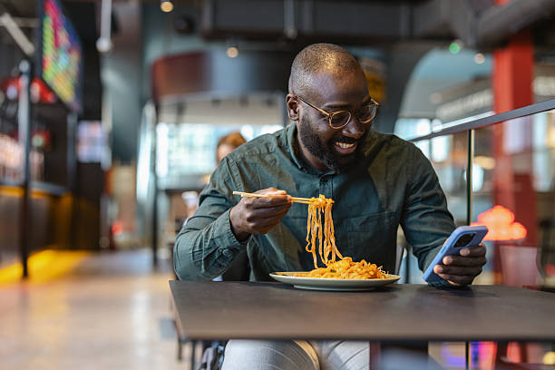 istock Man enjoys Asian food at a self-serving restaurant during lunch break 2243925762