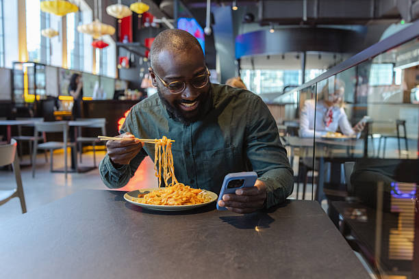 istock Man enjoys Asian food at a self-serving restaurant during lunch break 2243926291