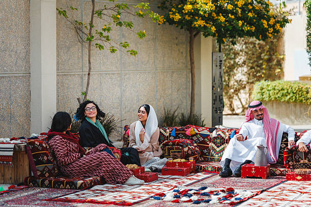 istock Middle Eastern Adults Sharing Laughter and Stories in Vibrant Outdoor Majlis Setting 2243926357